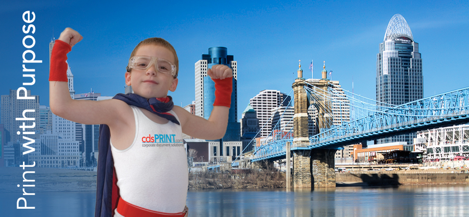 Cincinnati skyline with a child dressed as a superhero posing. non profit, print with purpose, rebate program, nonprofit printing, corporate document solutions